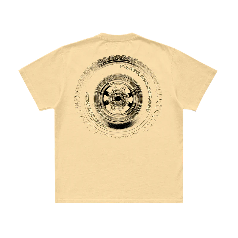 Back view of cream Post Malone F-1 Trillion shirt with oversized vintage tire graphic and western-inspired artwork
