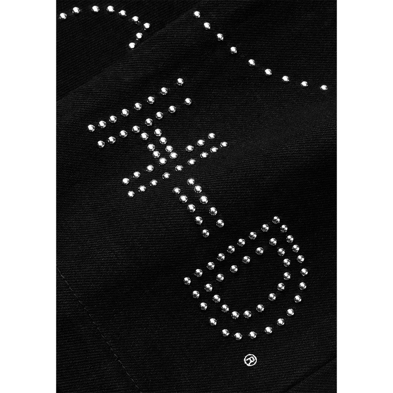Closeup of black Post Malone merch denim pants featuring rhinestone western graphic detailing on premium fabric.