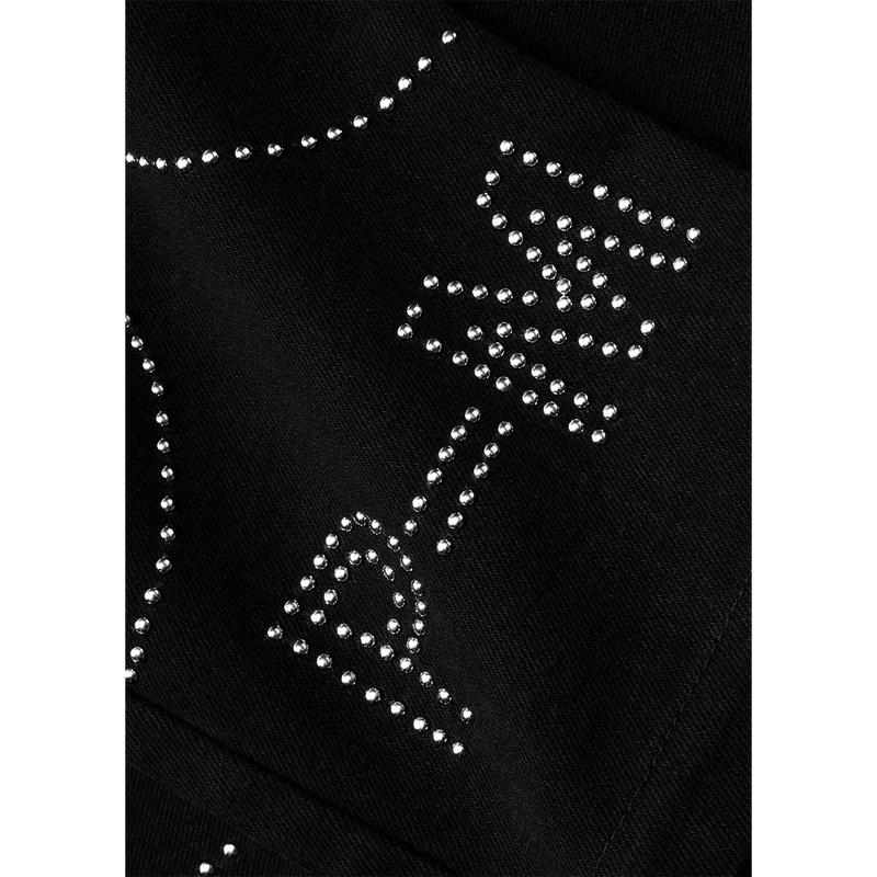 Closeup of black Post Malone merch pants featuring silver stud embellishments and western streetwear artwork detail.