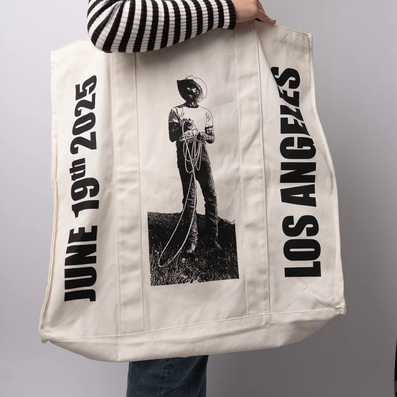 Cream Post Malone merch tote bag side view showing cowboy rope graphic and Los Angeles text design fan apparel streetwear